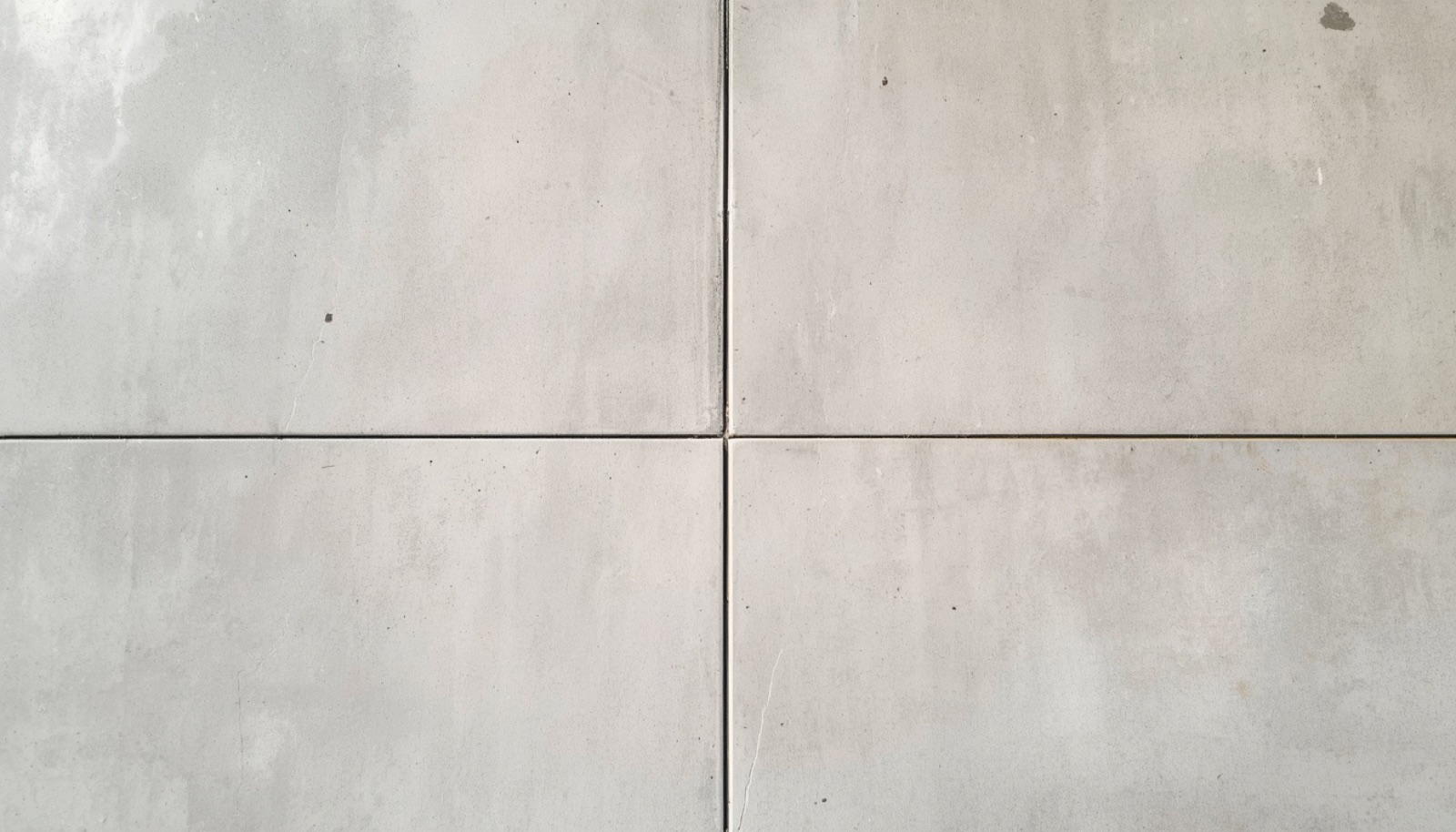 Driveway after Pelora Surfaces pressure washing, bright uniform clean concrete