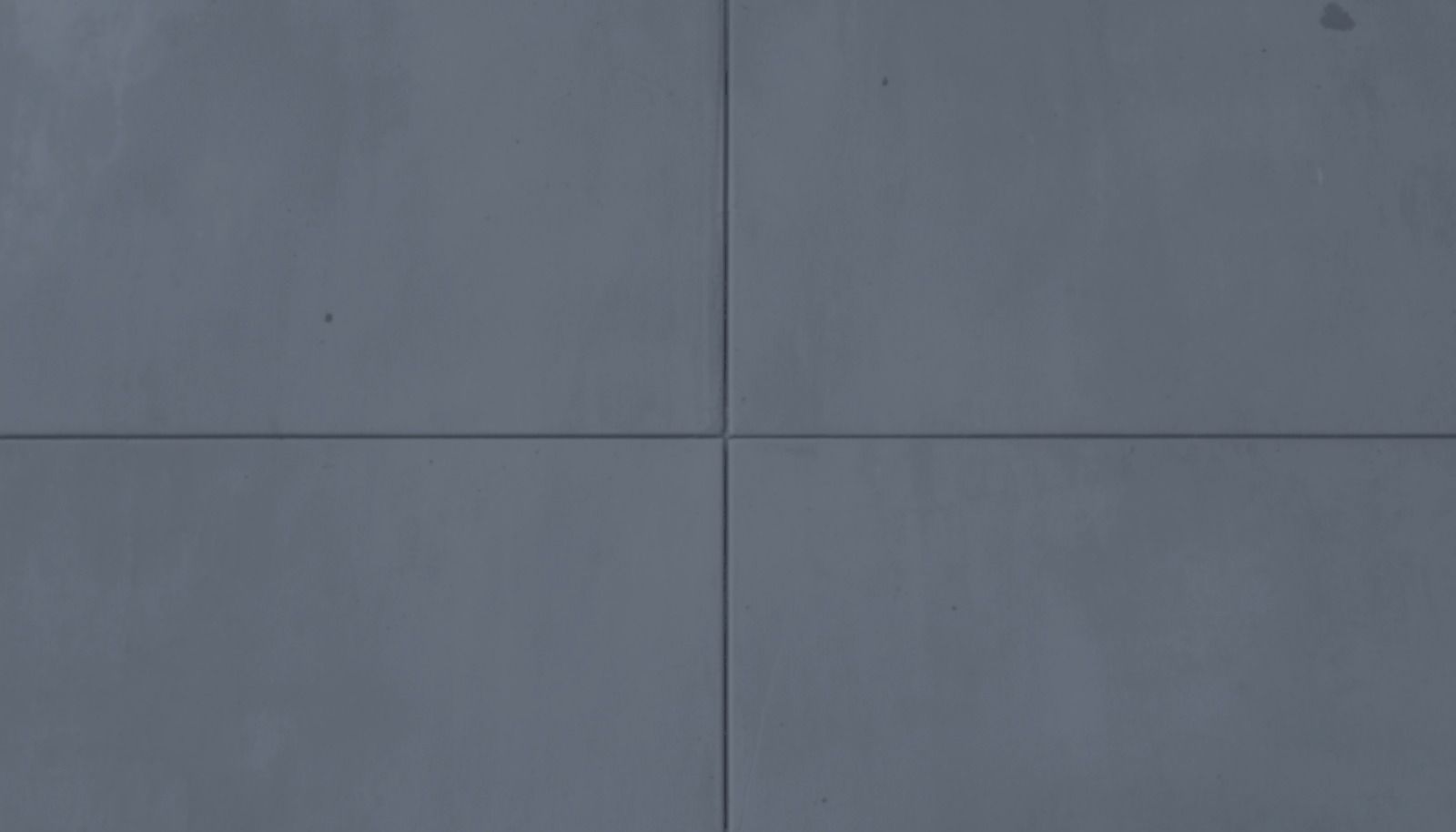 The same concrete slab finished in deep slate gray concrete paint