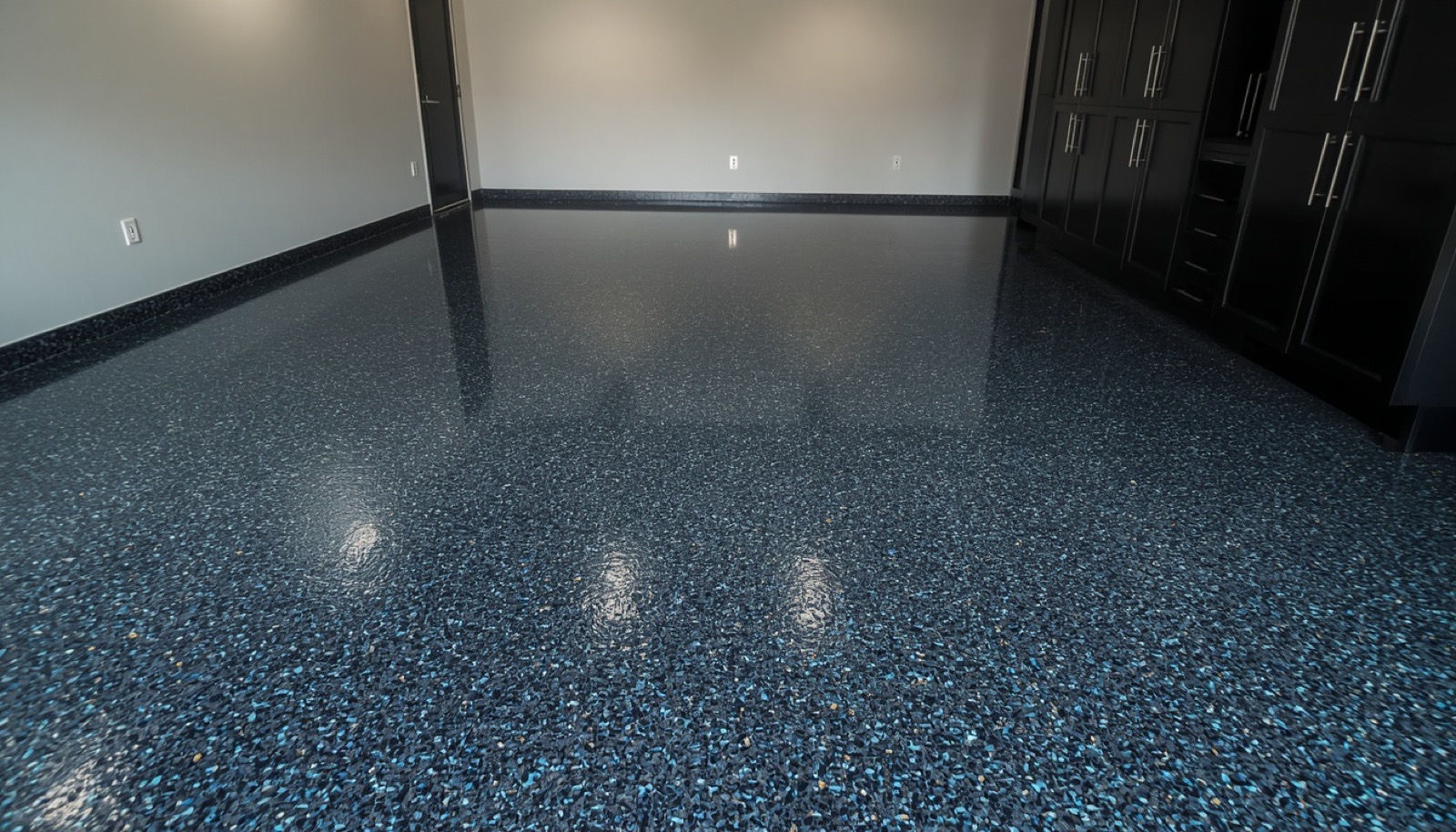 Finished garage with charcoal flake epoxy floor with blue accent chips