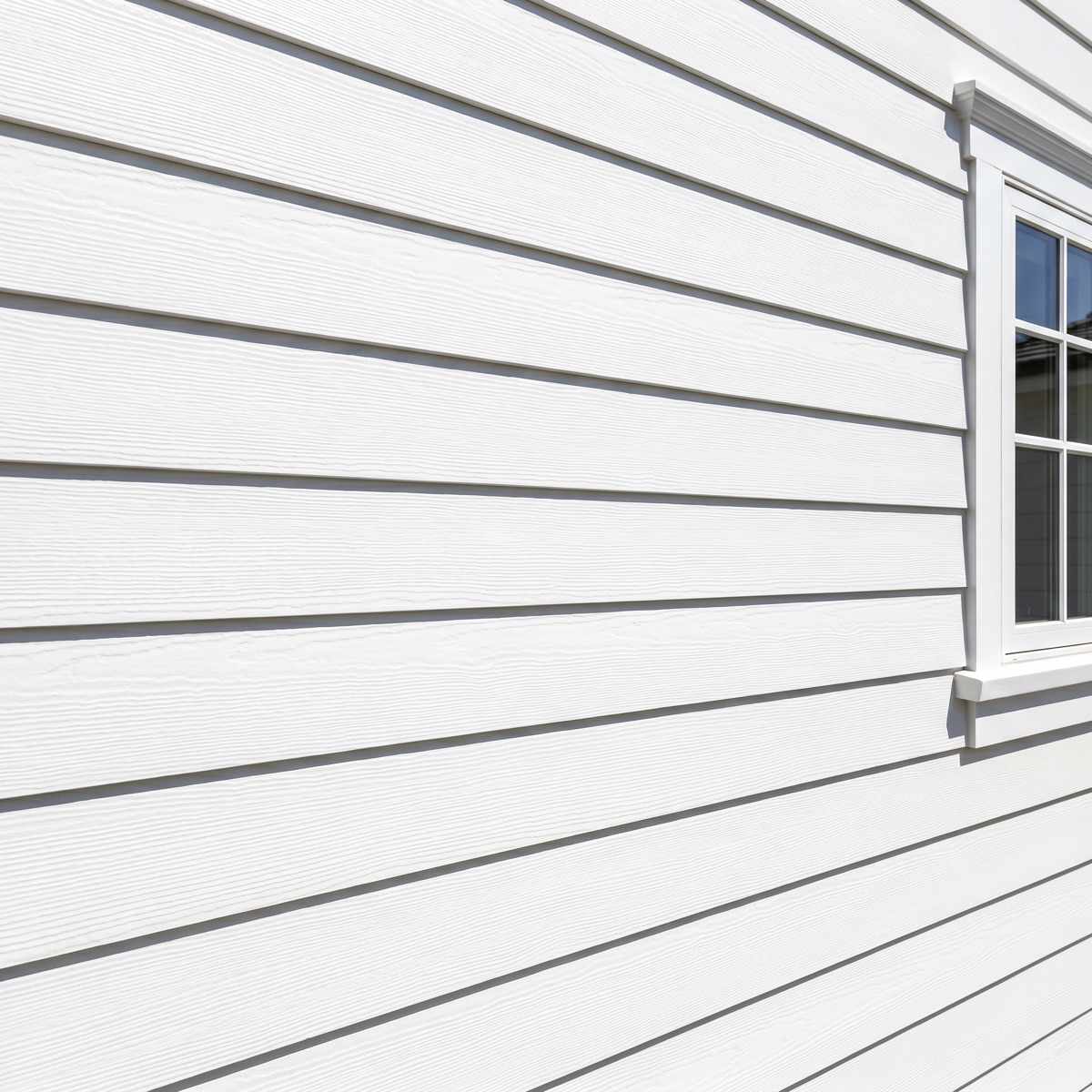 Bright clean white lap siding on a home after a professional soft wash